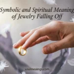 Ring falling off a hand in symbolic soft lighting